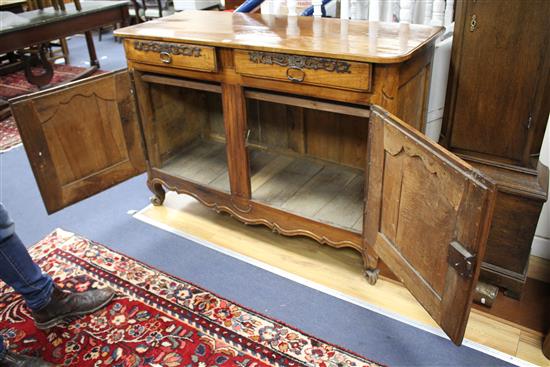 A late 18th century French provincial fruitwood side cabinet, W.138cm D.52.5cm H.94.5cm